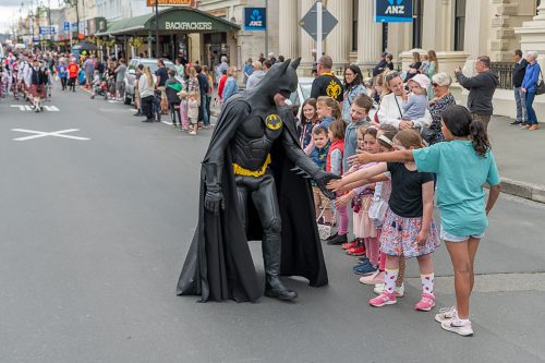 Oamaru Santa Parade 2022 - Batman shakes children's hands